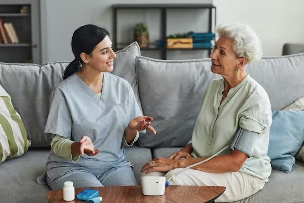 A carer chatting with a resident on the sofa