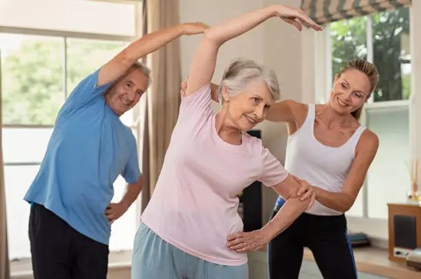 Residents stretching in a morning yoga class